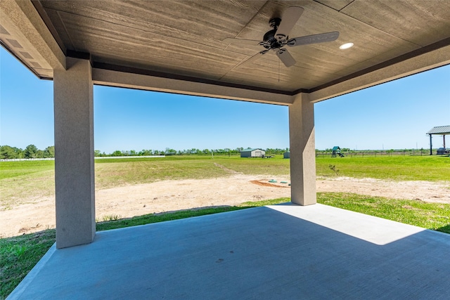 view of patio with ceiling fan and a rural view