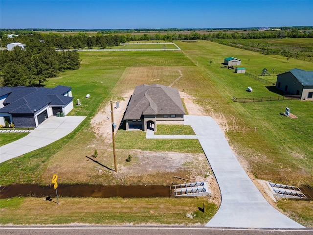 birds eye view of property with a rural view