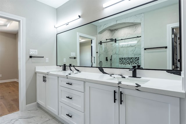 bathroom with vanity and a shower with shower door