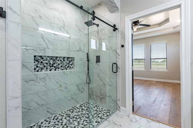 bathroom with walk in shower, ceiling fan, and hardwood / wood-style flooring