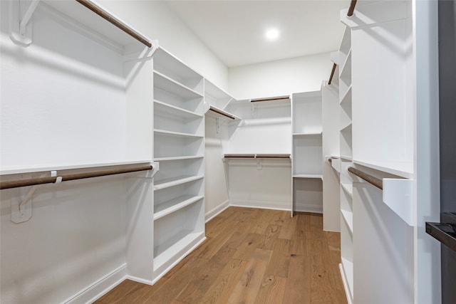 spacious closet with light hardwood / wood-style floors