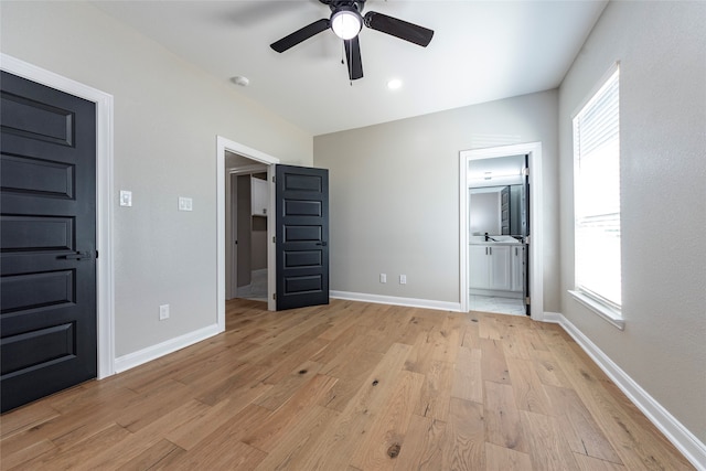 unfurnished bedroom with light hardwood / wood-style floors, ceiling fan, and ensuite bathroom