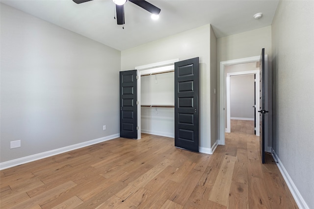 unfurnished bedroom featuring ceiling fan, light wood-type flooring, and a closet