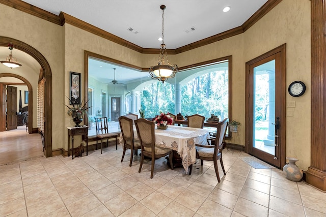 tiled dining room with a notable chandelier and crown molding