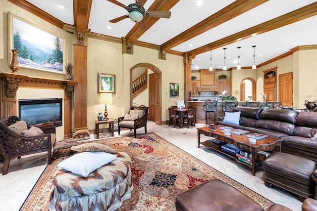 tiled living room featuring ceiling fan, crown molding, and beam ceiling