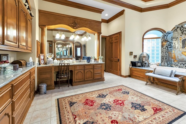 bathroom featuring tile patterned flooring, crown molding, a high ceiling, vanity, and ornate columns