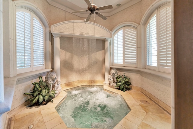 bathroom featuring a healthy amount of sunlight, ornamental molding, and ceiling fan