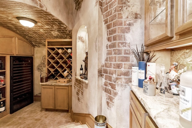 wine cellar featuring brick wall, brick ceiling, lofted ceiling, and light tile patterned floors