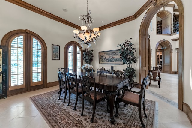 dining space featuring crown molding, an inviting chandelier, light tile patterned floors, and french doors