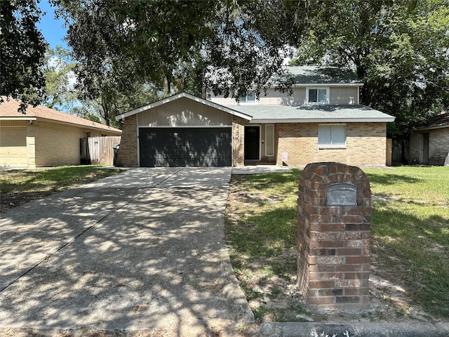 view of front of house featuring a garage and a front lawn