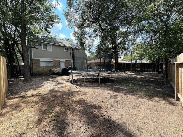 view of yard with a trampoline