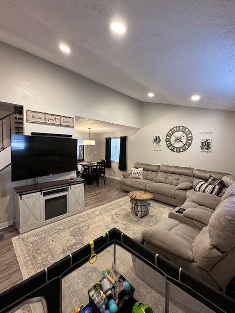 living room featuring wood-type flooring and a textured ceiling