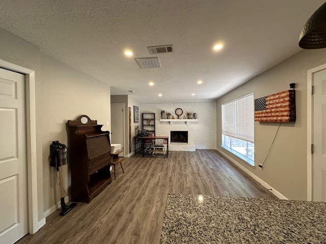 interior space with wood-type flooring and a textured ceiling