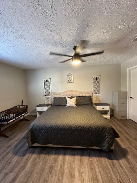 bedroom featuring wood-type flooring, a textured ceiling, and ceiling fan