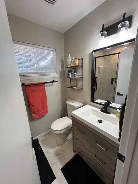 bathroom featuring vanity, a shower with door, a textured ceiling, and toilet