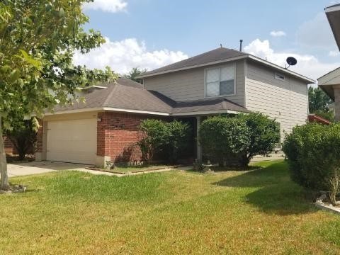 exterior space featuring a garage and a front yard