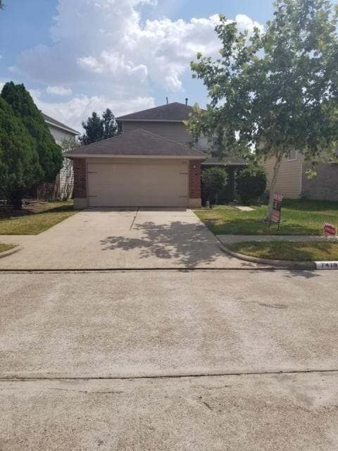 view of front of home featuring a garage and a front lawn