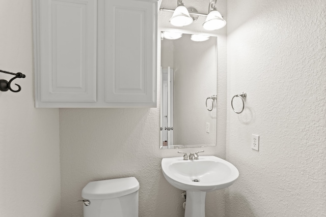 bathroom featuring toilet and sink