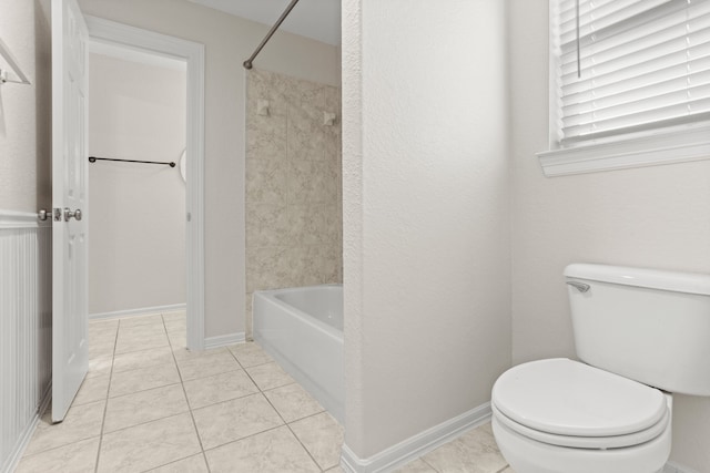 bathroom featuring shower / bathing tub combination, tile patterned floors, and toilet