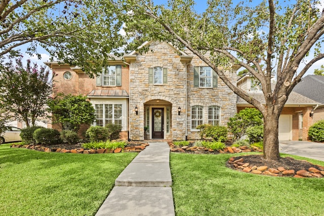 view of front facade with a garage and a front lawn