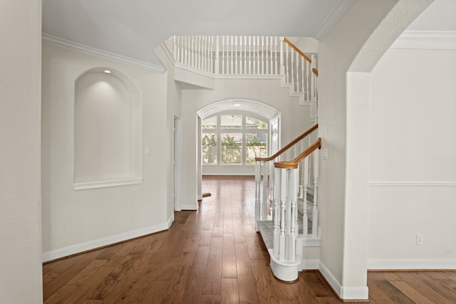 entryway featuring ornamental molding and hardwood / wood-style flooring