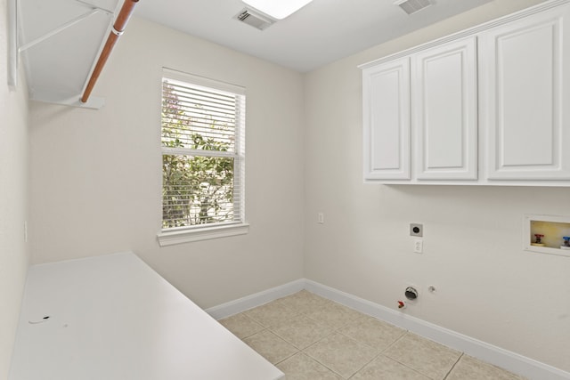 laundry room with cabinets, hookup for an electric dryer, hookup for a washing machine, and light tile patterned floors