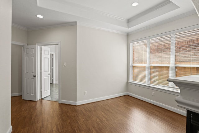 spare room featuring wood-type flooring and crown molding