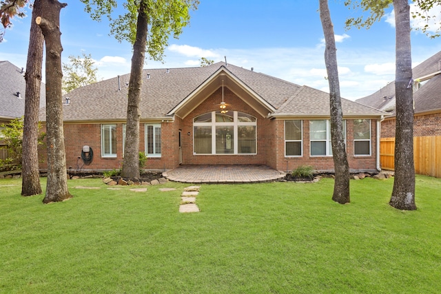 back of property featuring a lawn and a patio