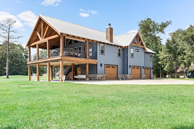 rear view of property with a lawn and a garage