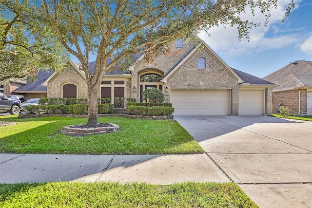 view of front facade with a front yard and a garage