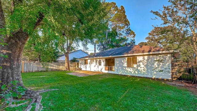 back of property featuring a yard and a patio area