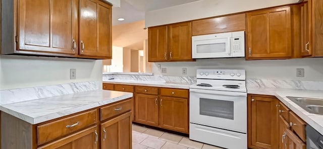 kitchen with white appliances and light tile patterned flooring