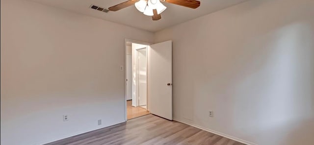 empty room with light hardwood / wood-style floors and ceiling fan