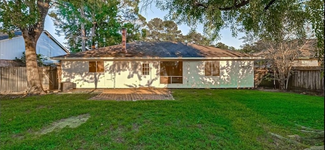 back of property featuring a lawn and a patio area