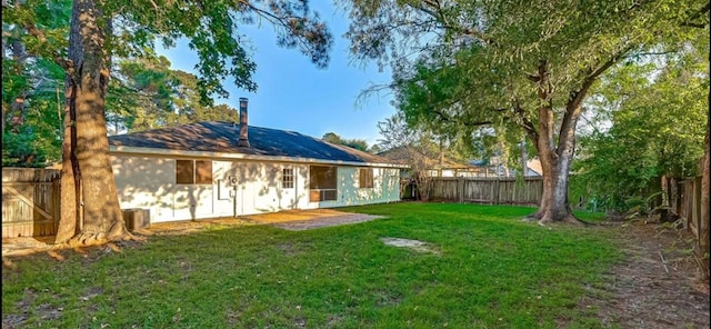 view of yard featuring cooling unit and a patio area