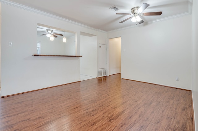 unfurnished room featuring ceiling fan, ornamental molding, and wood-type flooring