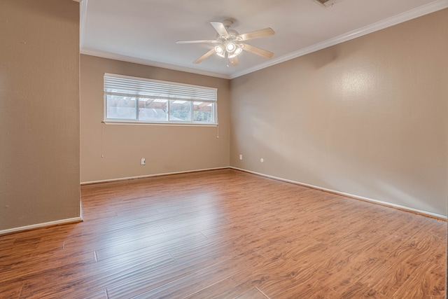 unfurnished room featuring ceiling fan, light wood-type flooring, and crown molding