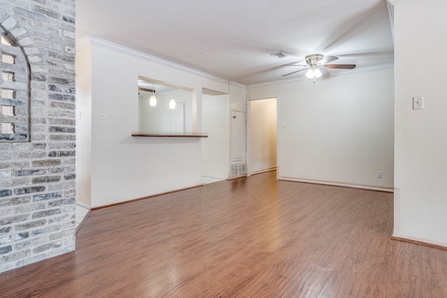 spare room featuring ceiling fan, hardwood / wood-style flooring, and crown molding