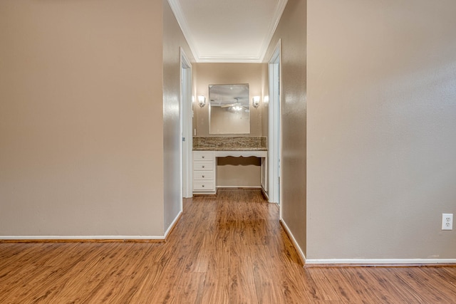 hallway with ornamental molding and light wood-type flooring