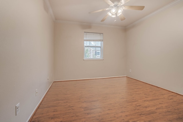 empty room with ornamental molding, hardwood / wood-style floors, and ceiling fan