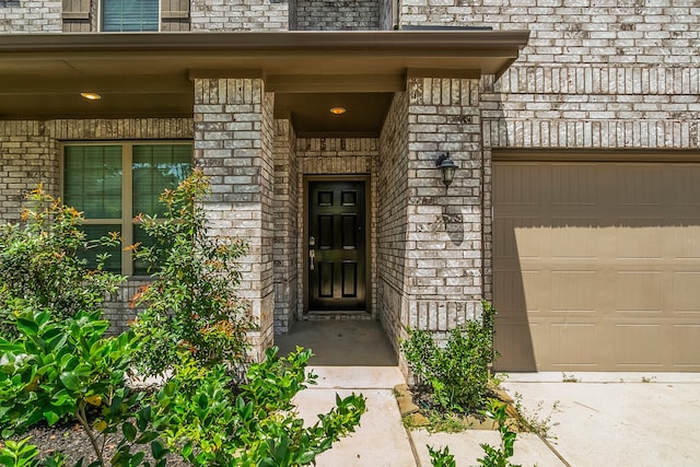 view of exterior entry with a garage