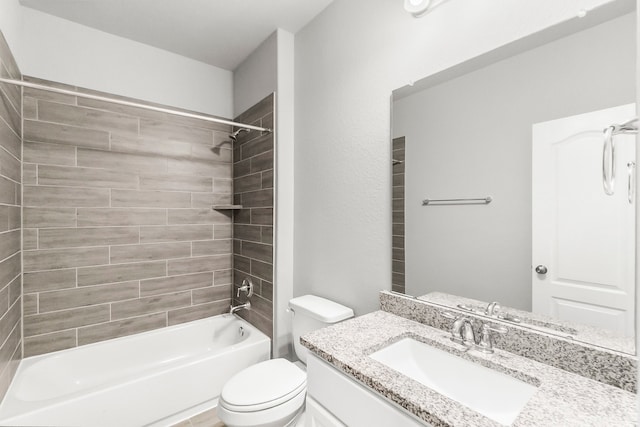 full bathroom featuring tiled shower / bath, vanity, and toilet