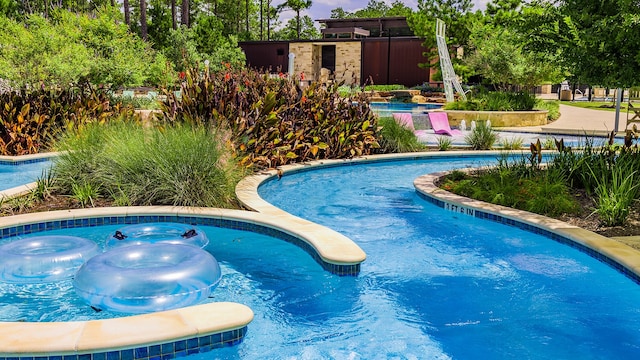 view of pool with a hot tub