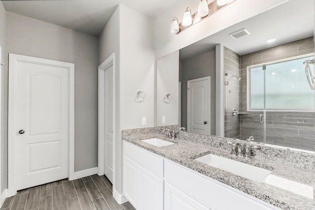 bathroom featuring vanity and an enclosed shower