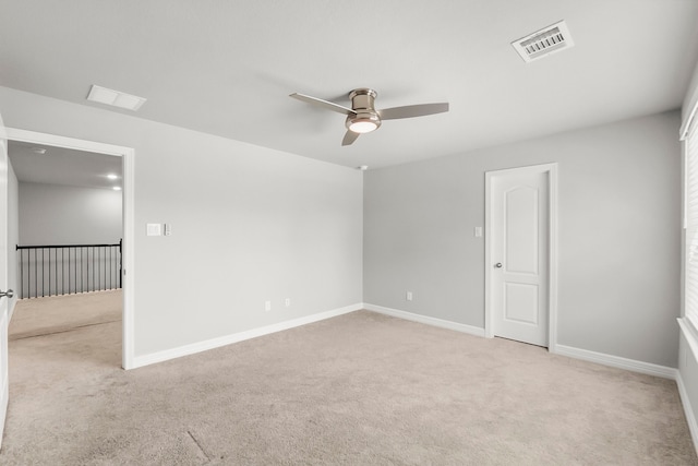 spare room featuring ceiling fan and light colored carpet