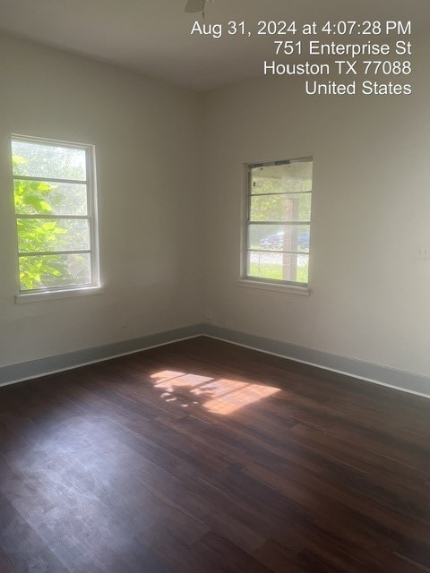 empty room with ceiling fan and dark hardwood / wood-style floors