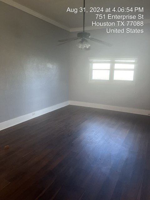 spare room featuring ornamental molding, ceiling fan, and dark hardwood / wood-style flooring