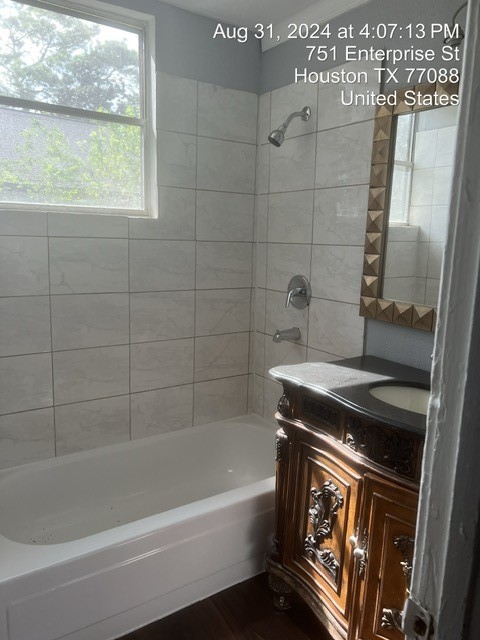 bathroom with vanity and tiled shower / bath combo