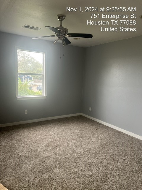 carpeted empty room featuring ceiling fan