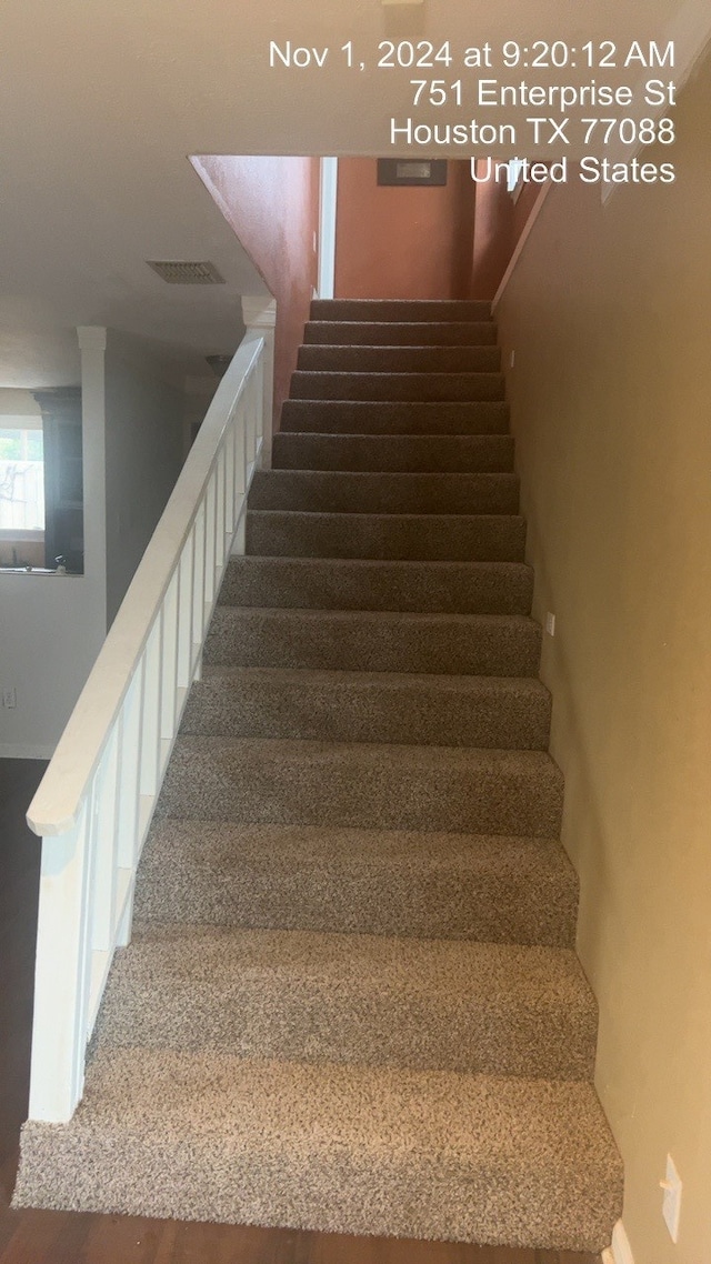 stairway featuring wood-type flooring